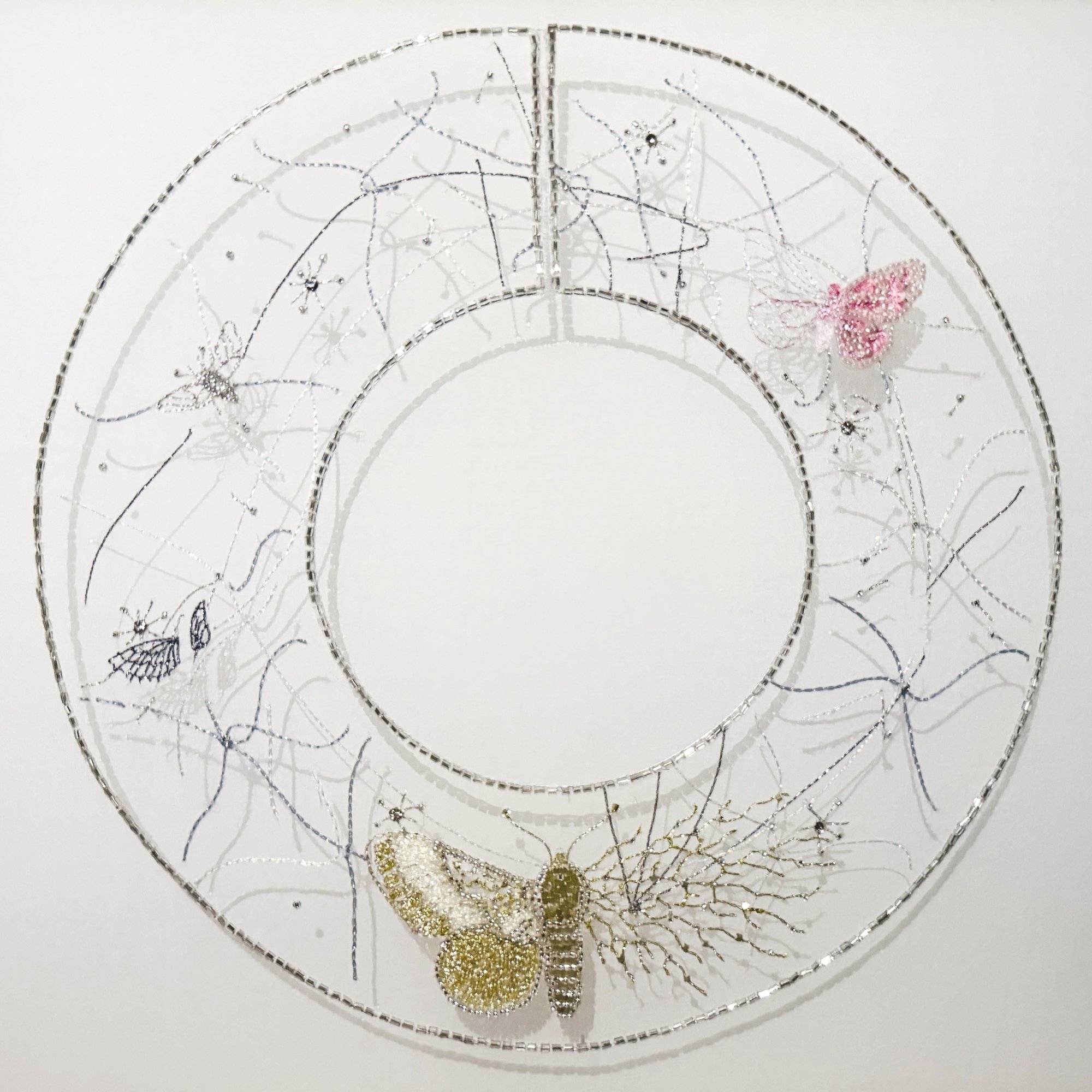 The filament collar: a hand-embroidered collar on silk organza with moths and fine mycelial lines.