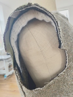 The armscye prepared for setting the sleeve.
