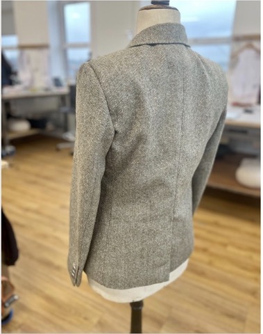 The finished jacket from the back: shoulder line, sleeve setting and centre-back vent.