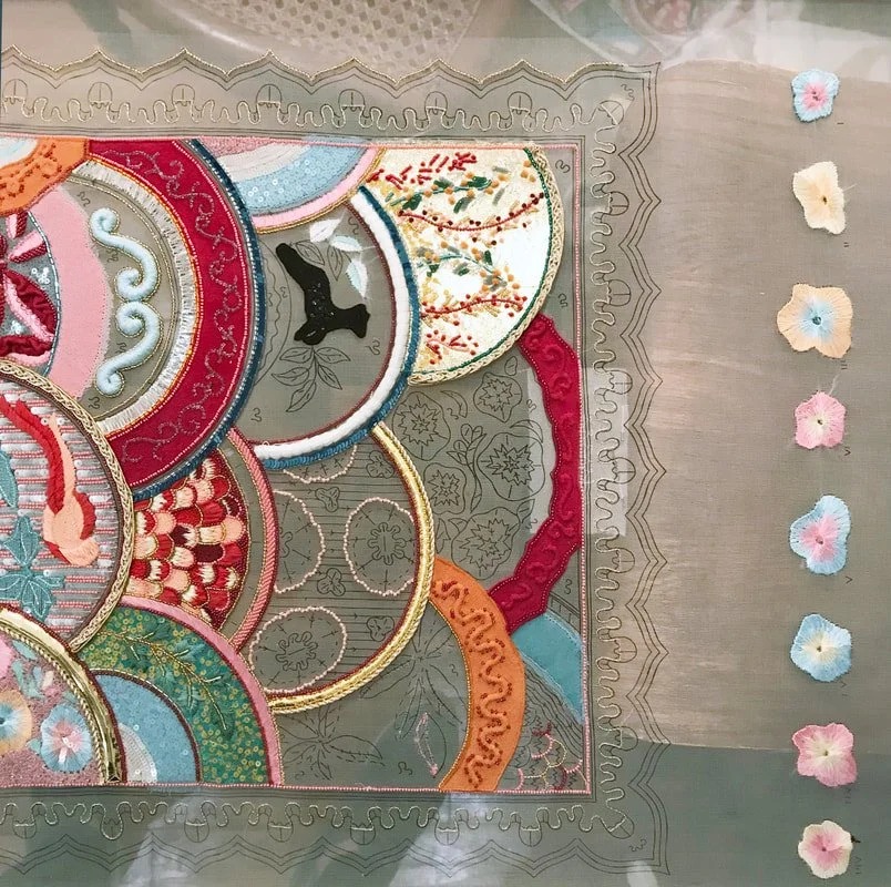 The sampler on the frame, with a column of small appliqué flowers along the right edge.