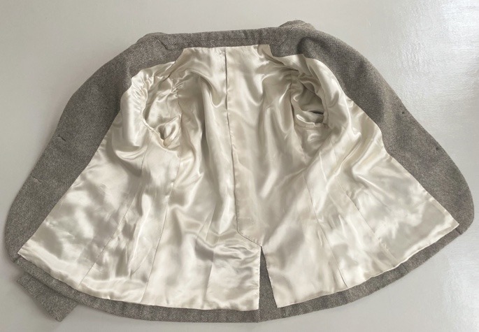 The jacket laid open to show the lining felled by hand.