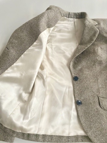 The inside front of the jacket with its lining and buttons.