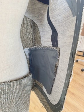 A pocket bag set through the jacket front, with canvas and stay tape visible.